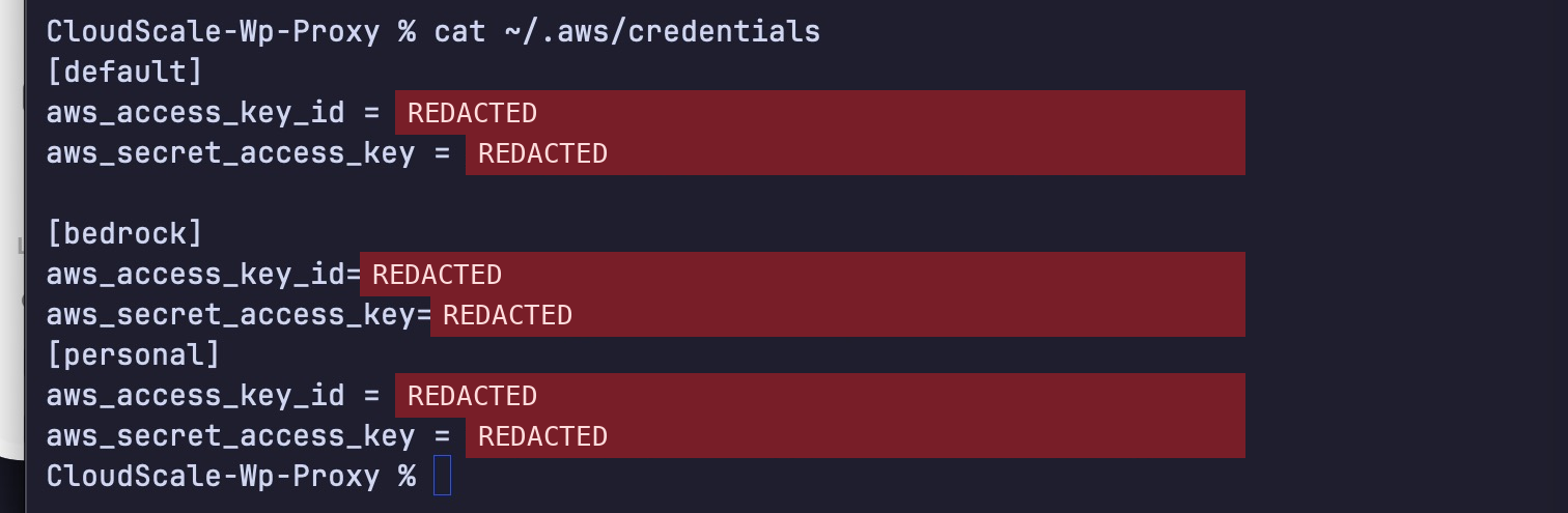 cat ~/.aws/credentials printing three AWS access keys and secrets in plain text, redacted
